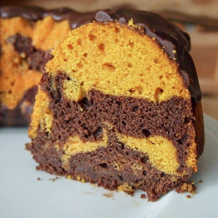 Chocolate Pumpkin Cake on a platter with a slice cut out.