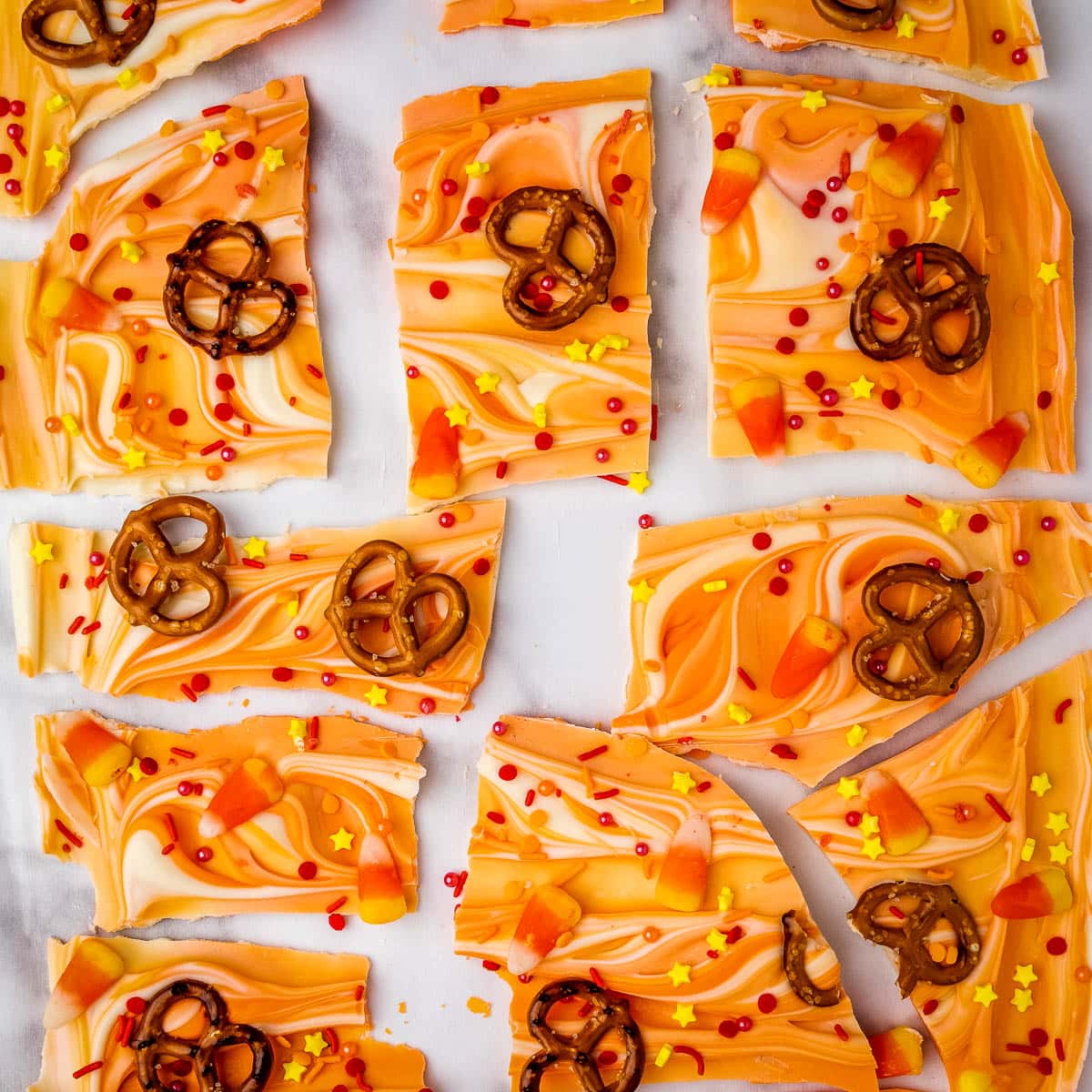 pieces of candy bark with pretzels and sprinkles