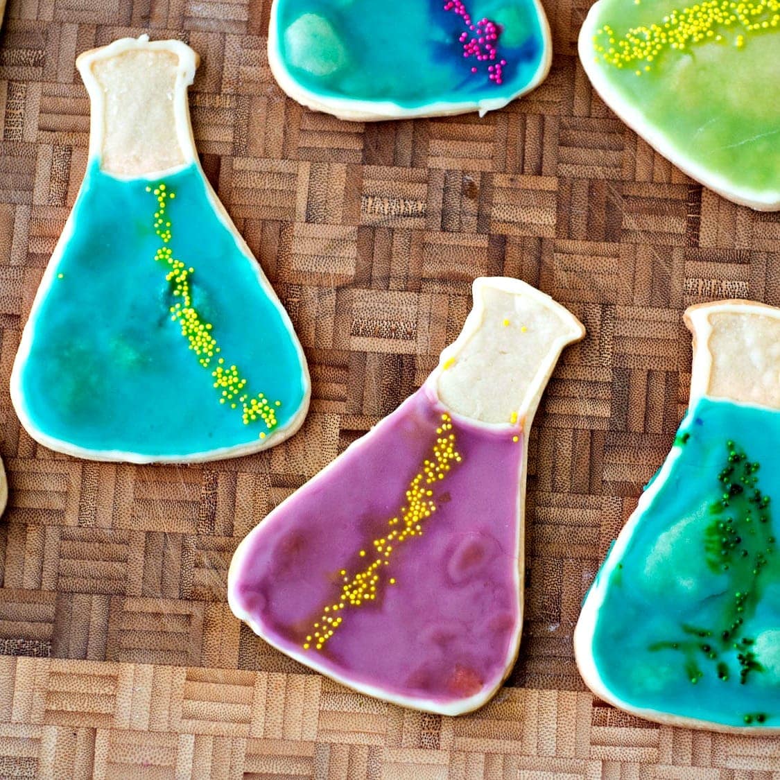 A group of cookies with icing in the shape of a flask.