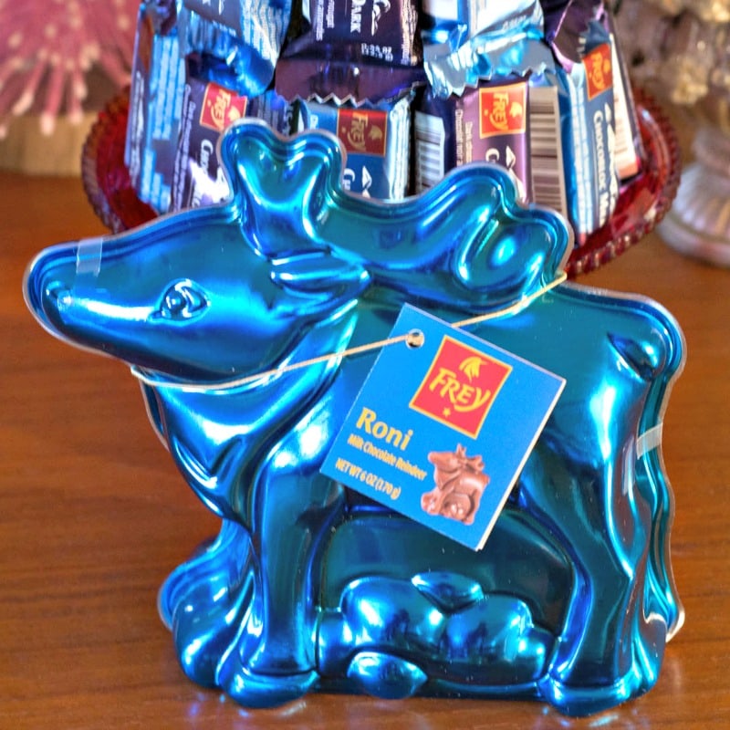 A blue reindeer shaped candy holder on a table.