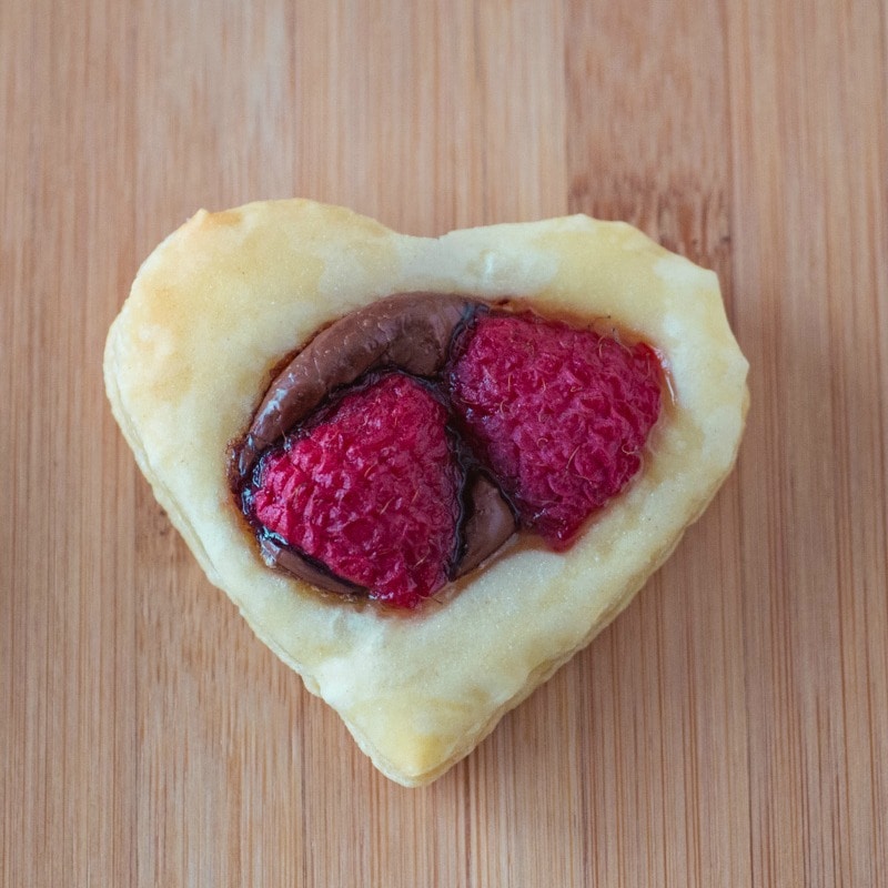Puff Pastry Cookie shaped like a heart - with Nutella and raspberries