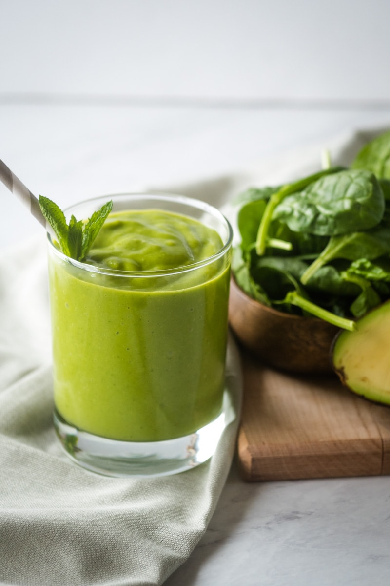 Make this easy and delicious mango avocado smoothie! This creamy green smoothie is made from mango, avocado and spinach for a mango green smoothie that is packed with healthy fats and vitamins. Dairy free and vegan with only 5 ingredients it is perfect for breakfast or a quick snack! #smoothie #greensmoothie