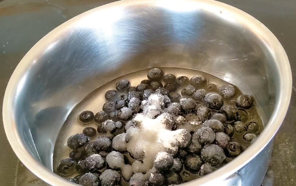 blueberries, orange juice and sugar in sauce pan