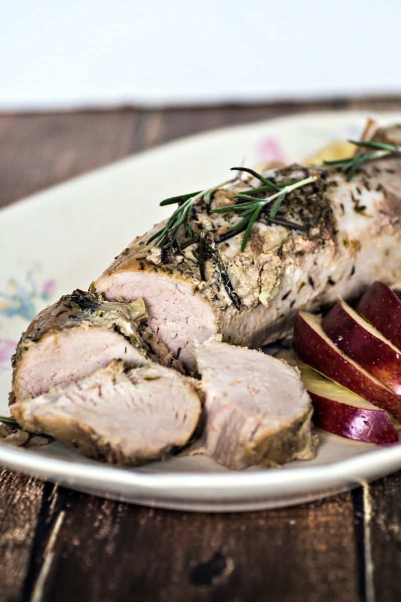 A delicious slow cooker recipe for pork tenderloin with apples. The pork roast is combined with apples and onions and cooked in apple cider for an easy meal that goes together in 10 minutes and tastes amazing - a perfect meal for a busy weeknight. #pork #slowcooker #crockpot #porktenderloin