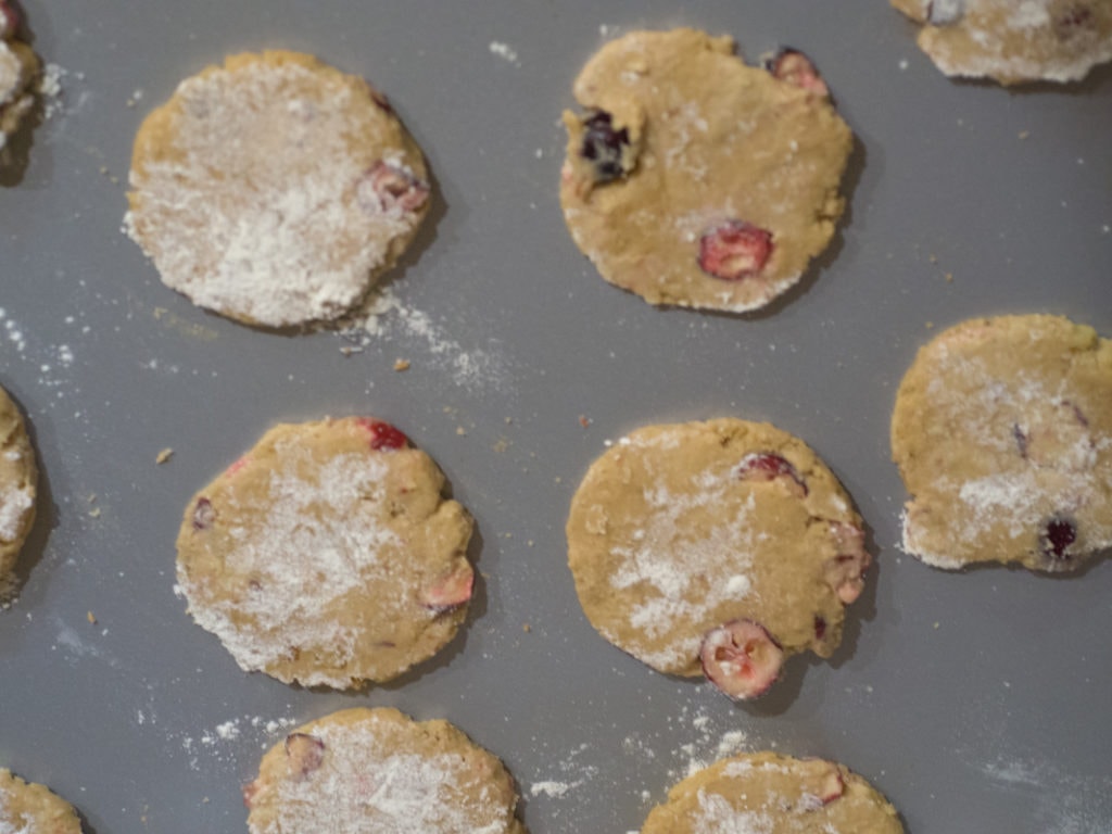 cookie sheet with unbaked cranberry walnut cookies