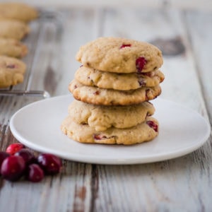 stack of cranberry cookies on a white plate