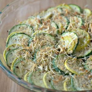 A zucchini casserole dish loaded with parmesan cheese.