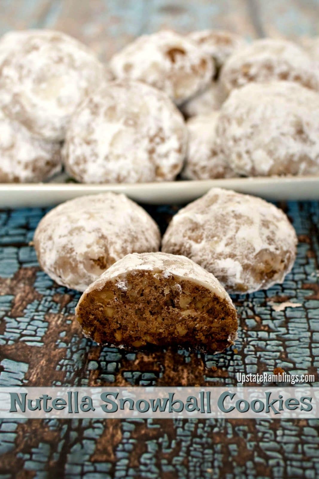 Russian Tea Cakes (Snowball cookies or Mexican Wedding Cake cookies) are a crumbly and buttery winter treat & a yummy Christmas cookie! Fun to make and eat - Nutella and walnuts mixed and coated in powdered sugar #cookies #christmascookies #snowballs