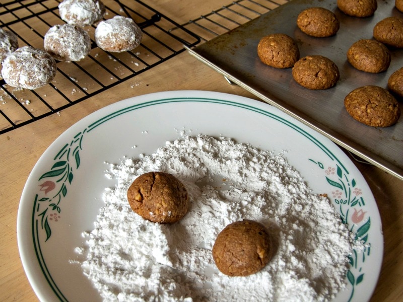 Rolling the Russian tea cakes in powdered sugar