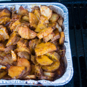cheesy grilled potatoes in a foil pan