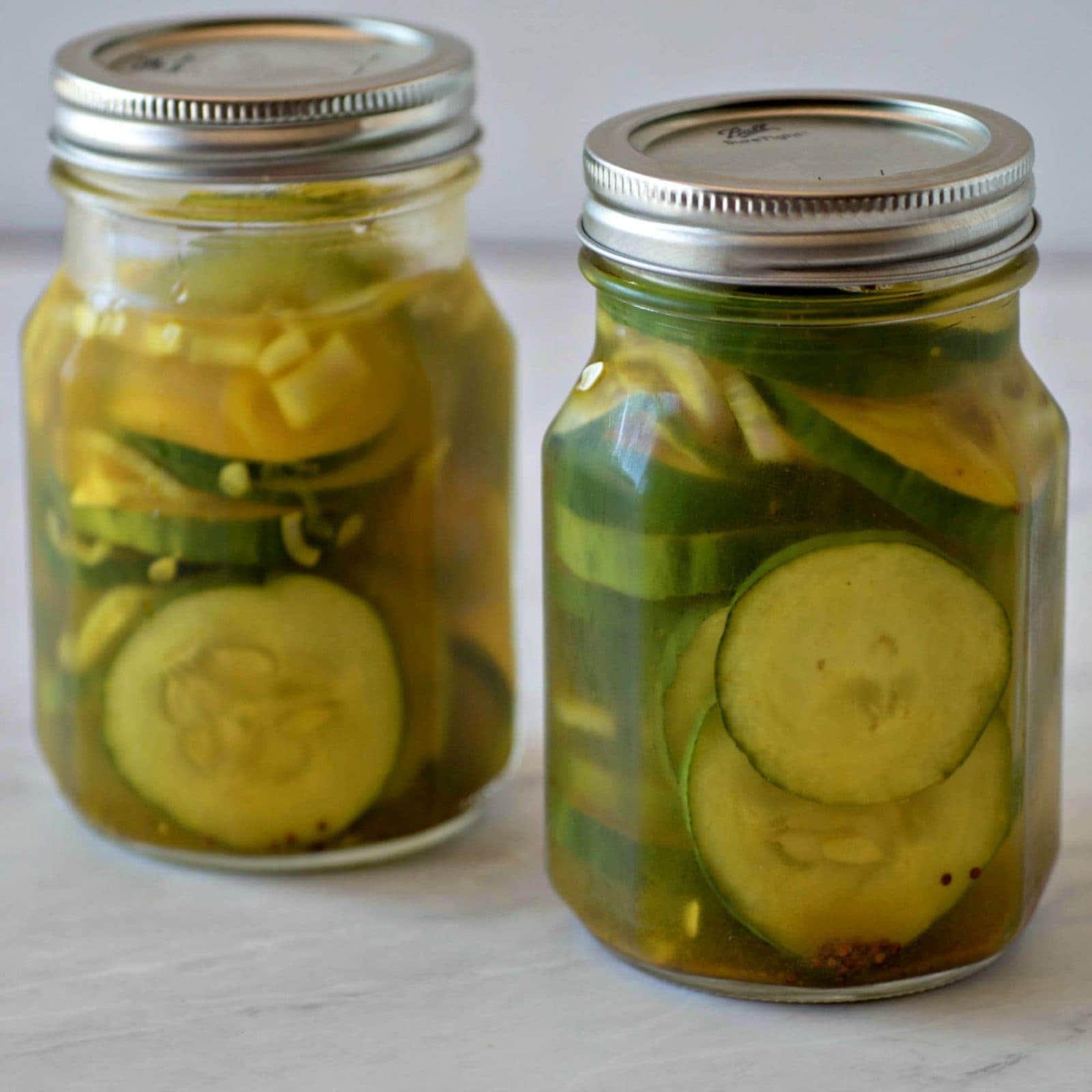 Two jars of homemade refrigerator bread and butter pickles