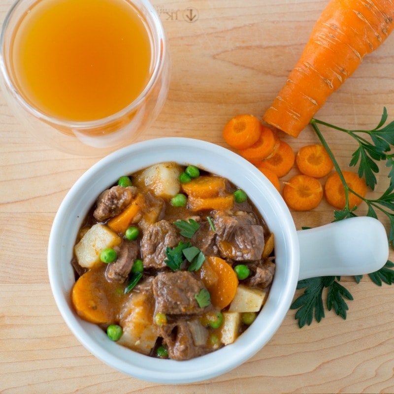 Bowl of Instant Pot beef stew with carrots and potatoes.