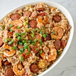 Instant pot jambalaya with rice, sausage, and shrimp in a white bowl.