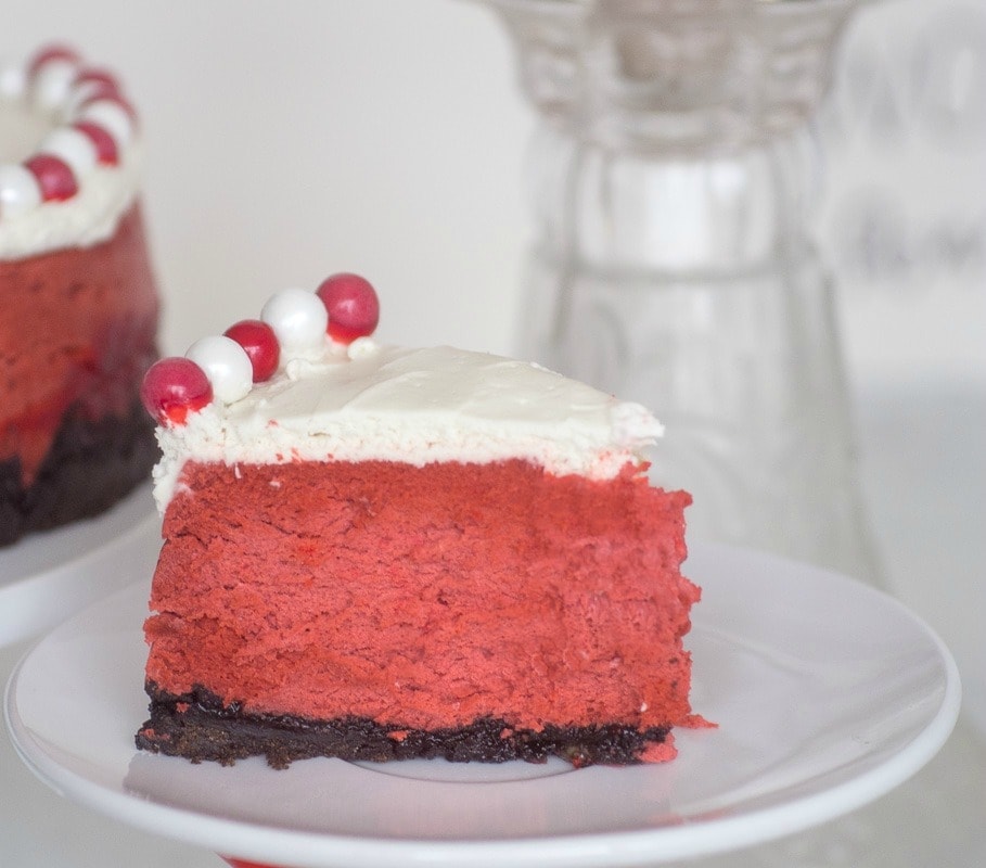 Slice of red velvet cheesecake on a plate.