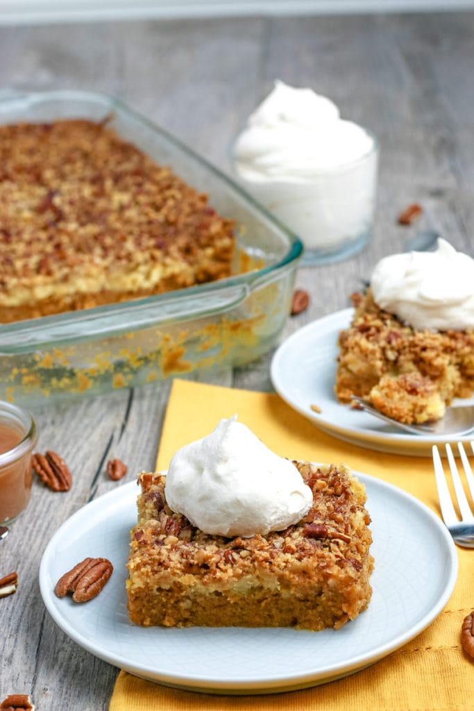 dump cake with slices cut out and topped with whipped cream