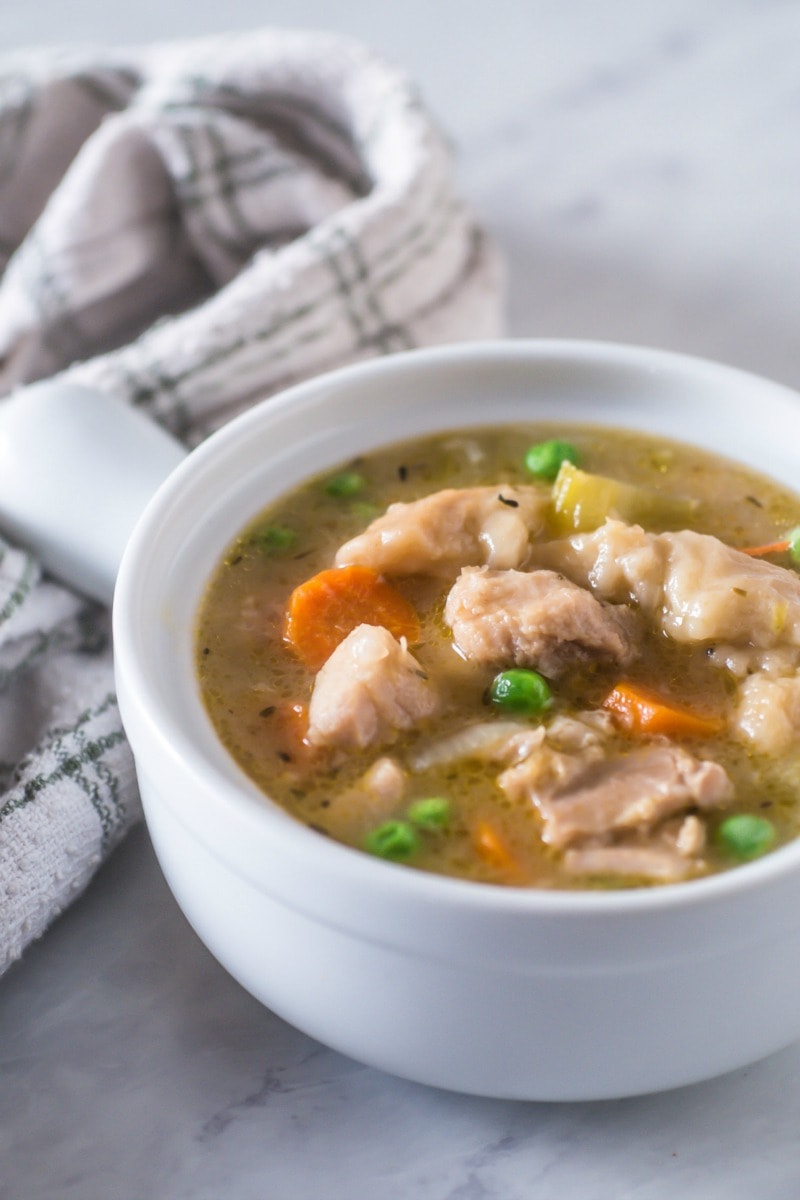 This recipe for Instant Pot Chicken and Dumplings is a quick and easy way to make a family favorite soup of tender chicken with squishy dumplings and lots of healthy vegetables. This easy homemade recipe is made with refrigerator biscuits for a one pot meal that can be ready in less than 30 minutes. #chicken #instantpot #dumplings #comfortfood