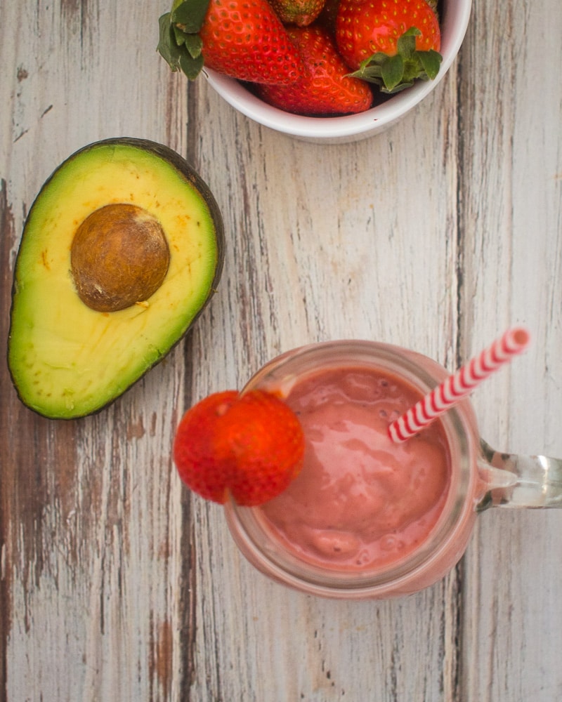 top view of a strawberry avocado smoothie with avocado and berries