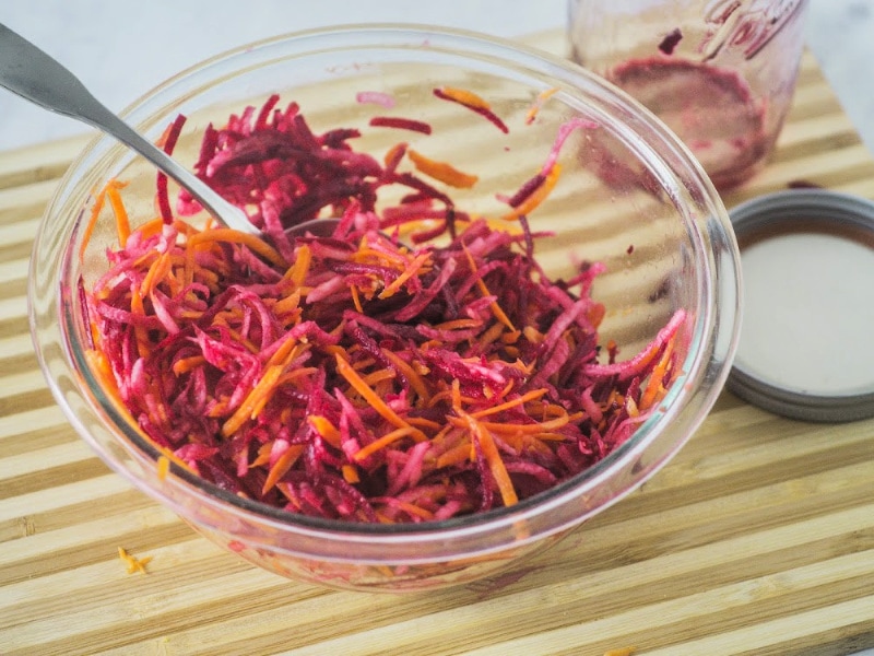 bowl of raw beetroot salad with apples and carrots