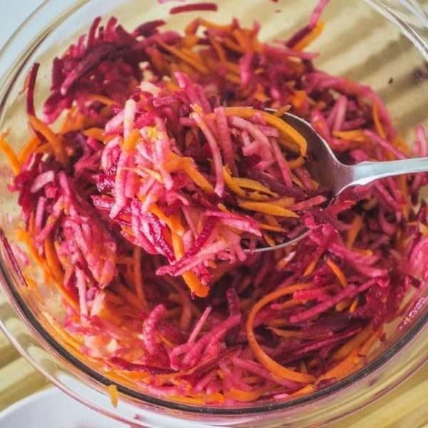 Big bowl of raw beet salad with apples and carrots