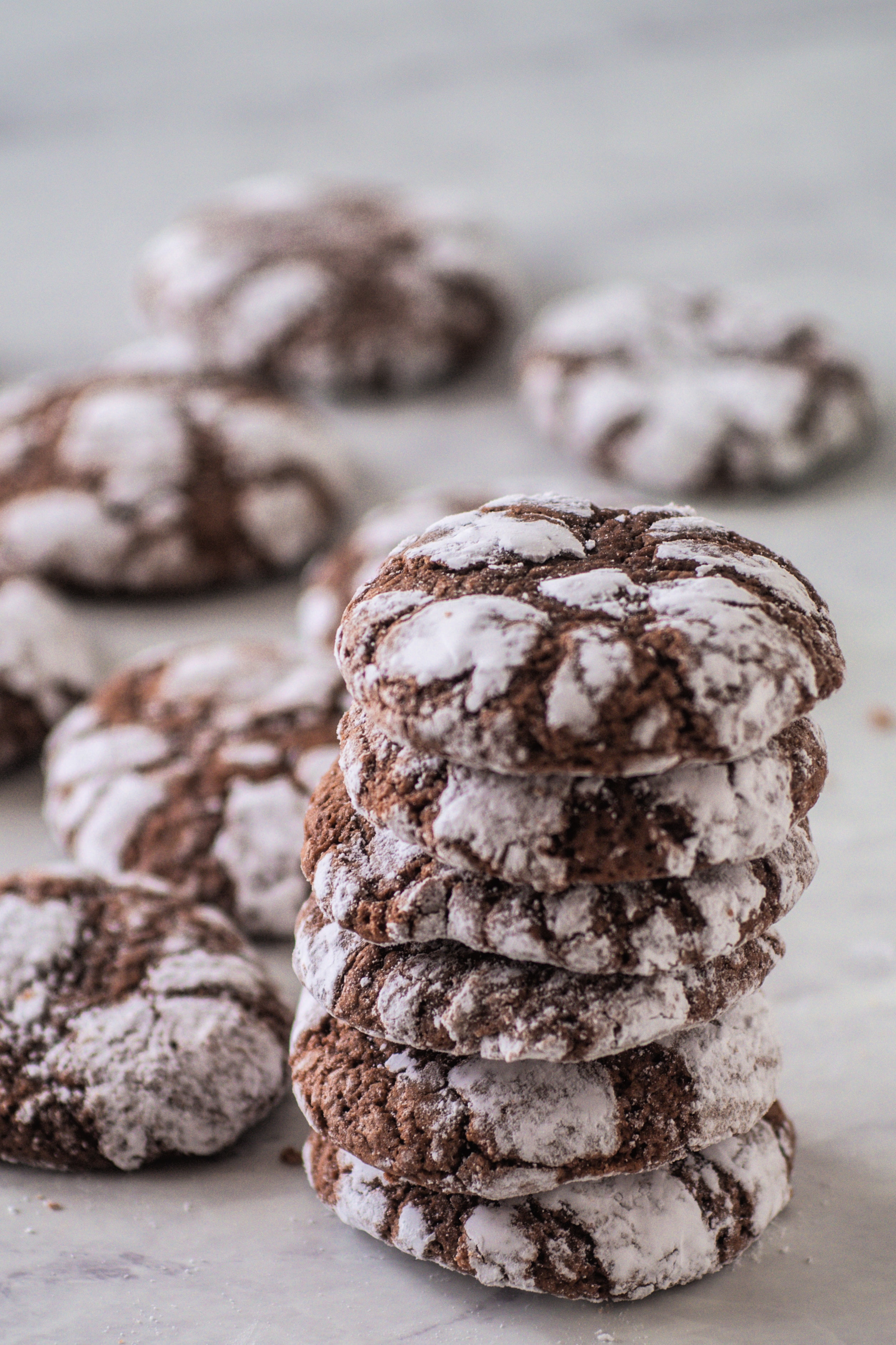 These Chocolate Crinkle Cookies are a classic chocolate cookie. The cookies are soft and chewy, with a gooey center, like a fudgy brownie. This dairy free cookie is easy and fun to make and will satisfy your sweet tooth. They are a traditional Christmas cookie, but tasty enough to make year round! #chocolatecookies #crinklecookies