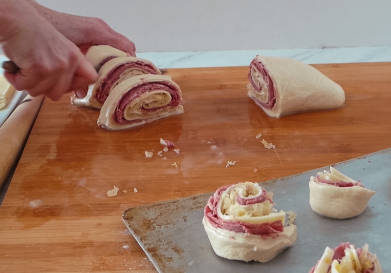 Making the reuben pizza roll - slicing the pizza dough