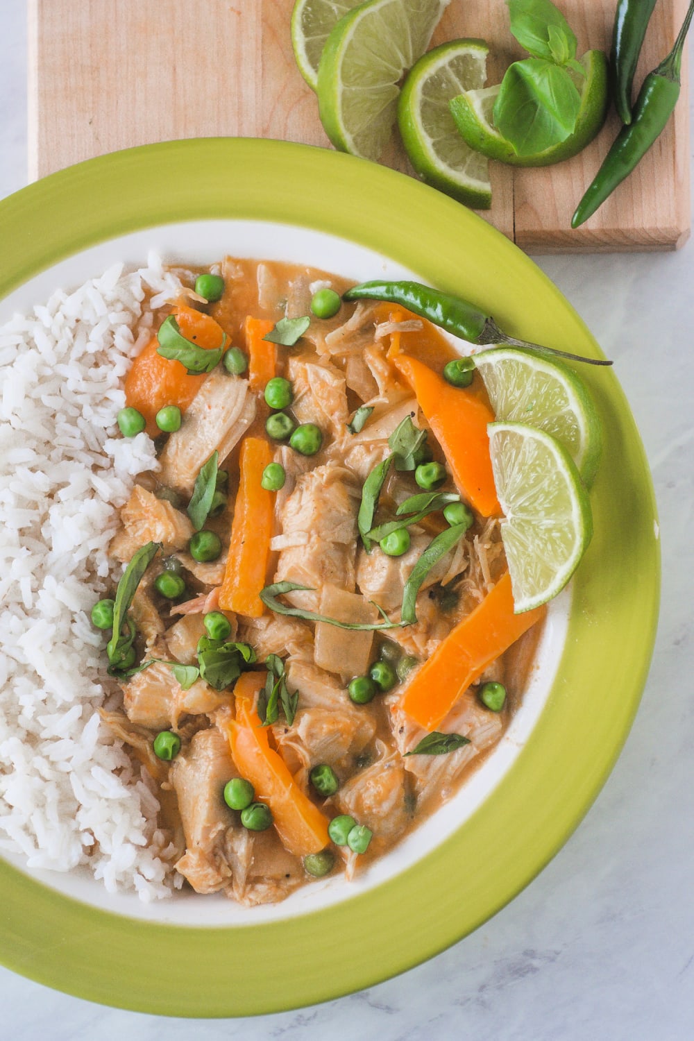 This Thai Red Chicken Curry is a quick and easy one pot meal, with tender chicken and orange peppers simmered with red curry paste and coconut milk. This creamy weeknight meal can be made in less than 30 minutes for a restaurant style dish that is better than take out! #thai #curry