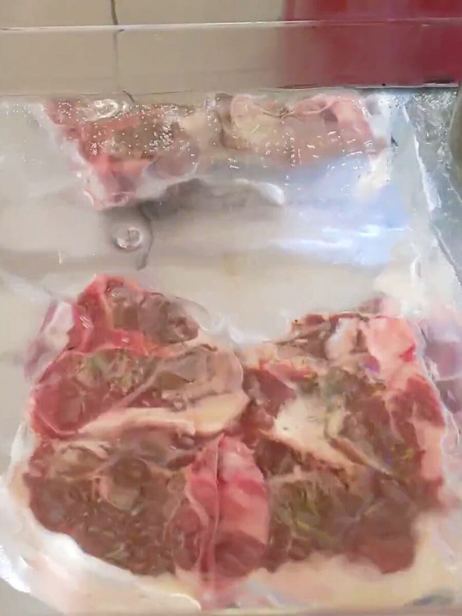 Lamb chops in the sous vide container.