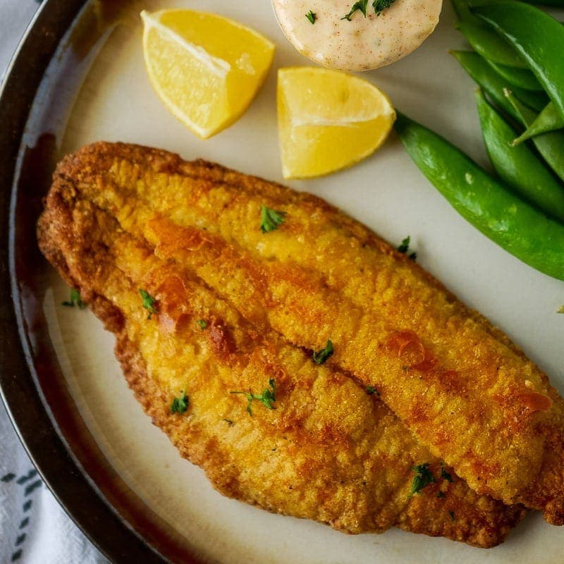 air fryer catfish with cornmeal on a plate from the top
