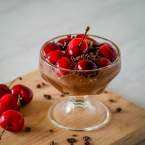chocolate chia pudding with cherries on top