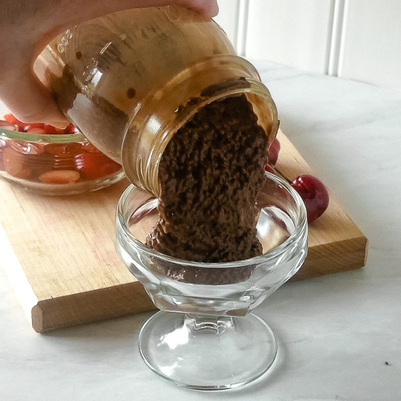 Pouring the chocolate chia pudding into dessert dishes