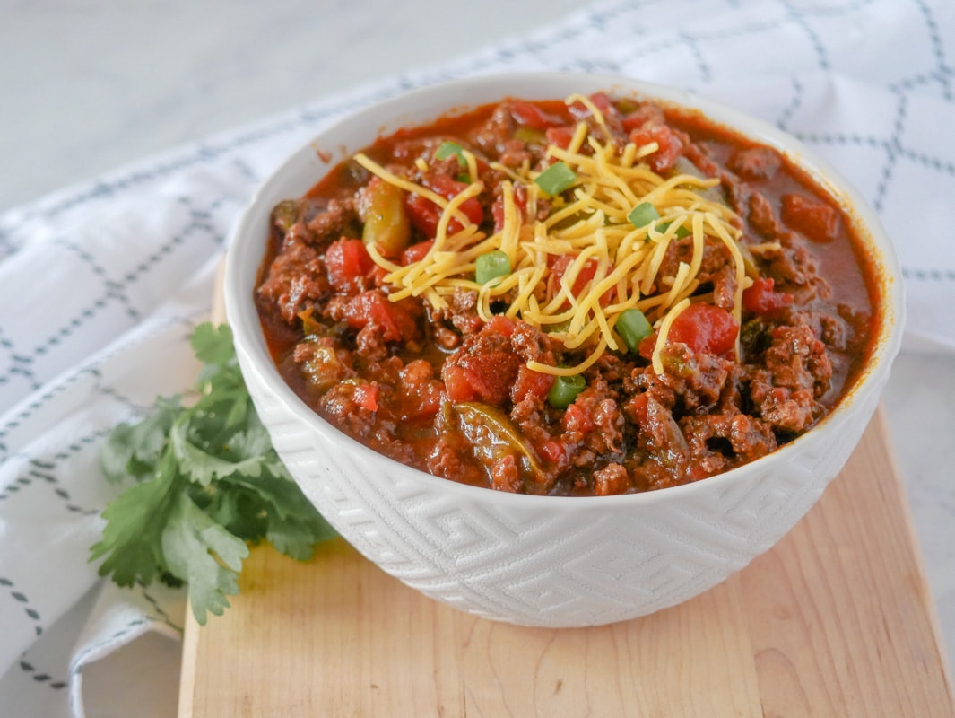 Bowl of chili in front of the Instant pot.