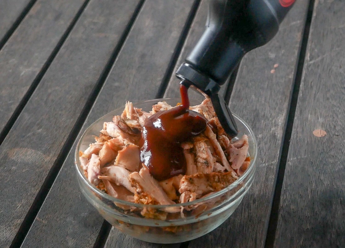 Mixing the BBQ sauce into the shredded chicken