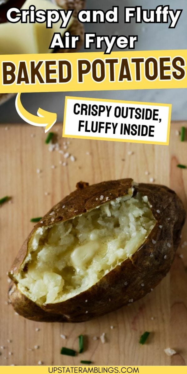 A baked potato with a crispy skin and fluffy interior is shown on a wooden surface, garnished with salt and chives. Text reads, "Crispy and Fluffy Air Fryer Baked Potatoes - Perfectly Crispy Outside, Fluffy Inside.