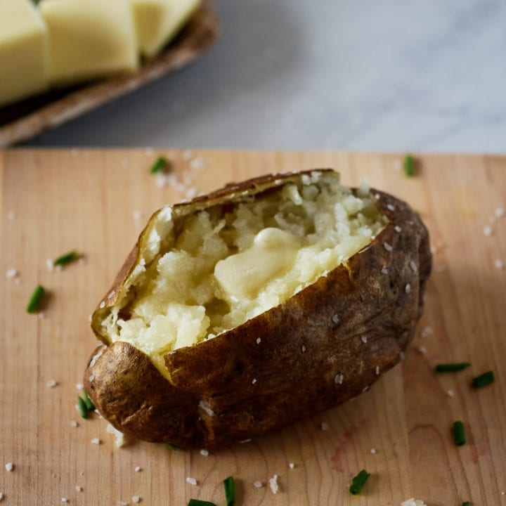 Air fryer baked potato on a cutting board