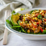 grilled chicken salad with corn and black beans in a bowl