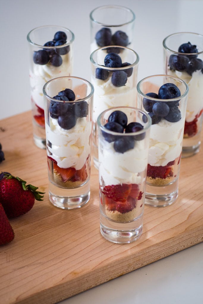 strawberries, no bake cheesecake filling and blueberries in a shot glass for a 4th of july dessert