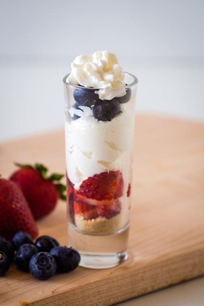 Mini cheesecake with fresh berries in a shot glass