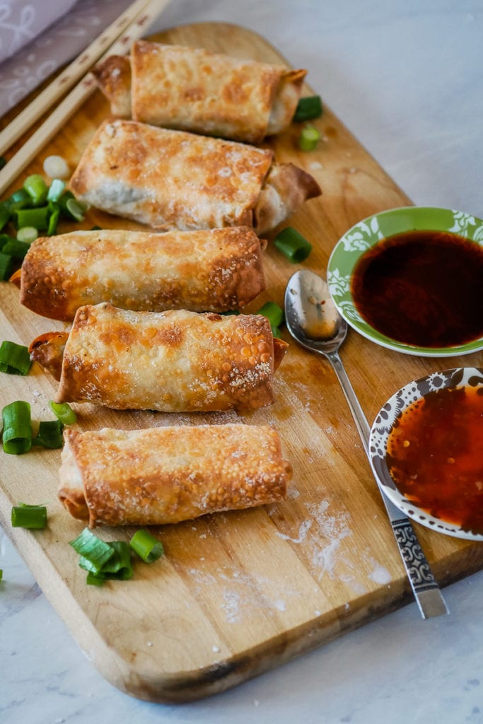 top view of homemade air fryer egg rolls with sauce bowls