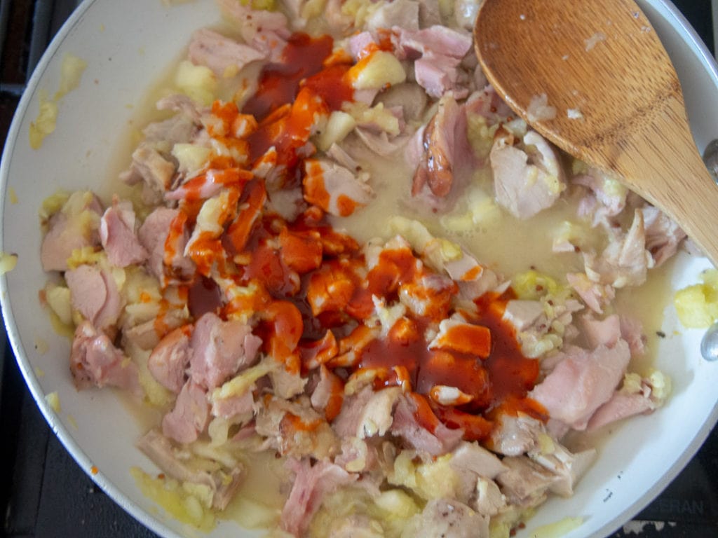 making the sauce for Buffalo chicken zucchini boat