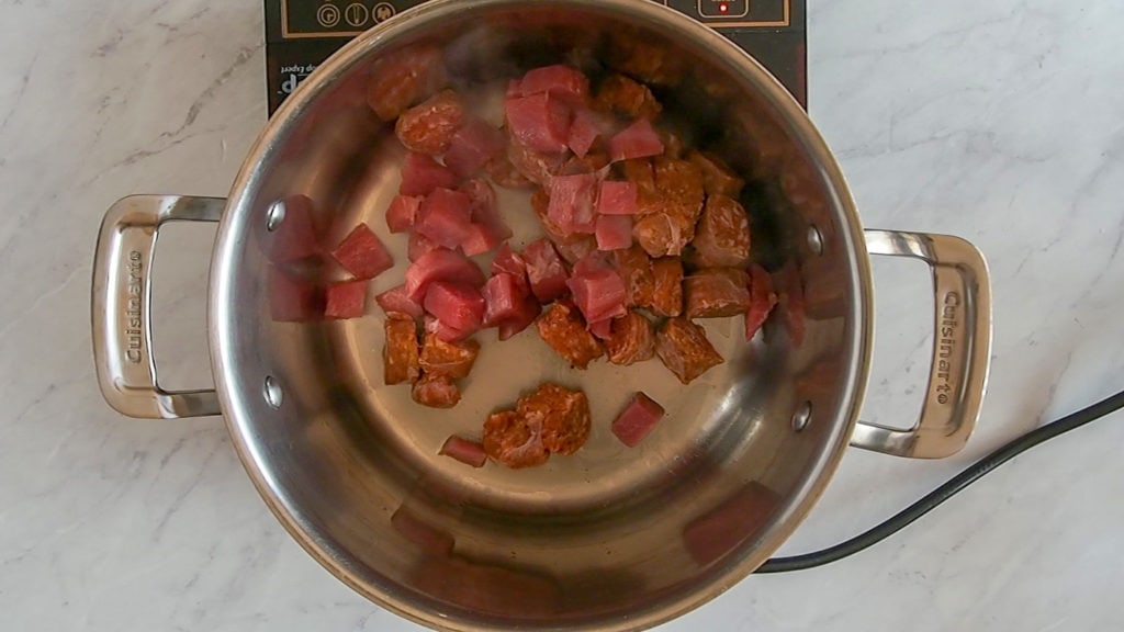 browning the meat for mushroom stew