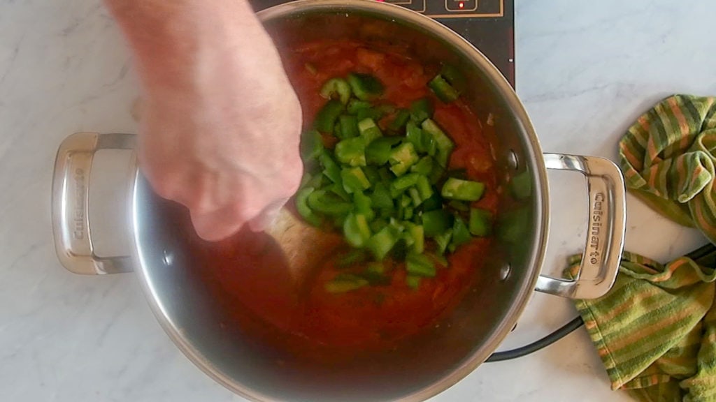 adding the green pepper to the Italian mushroom stew