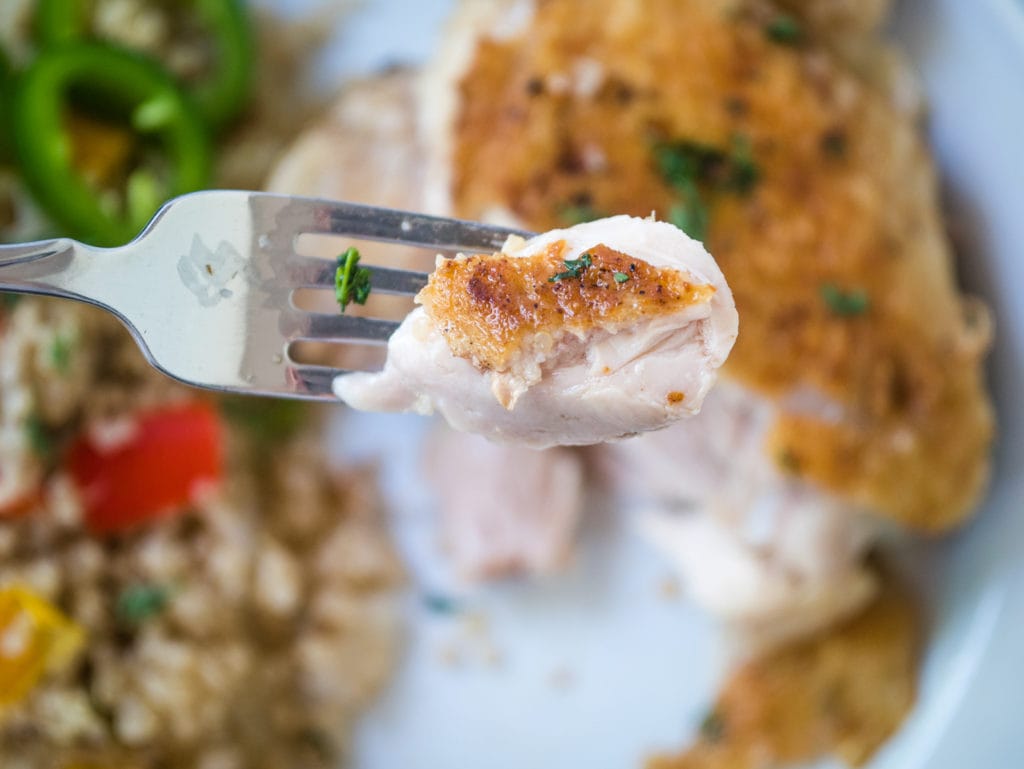 crispy chicken thigh on a fork