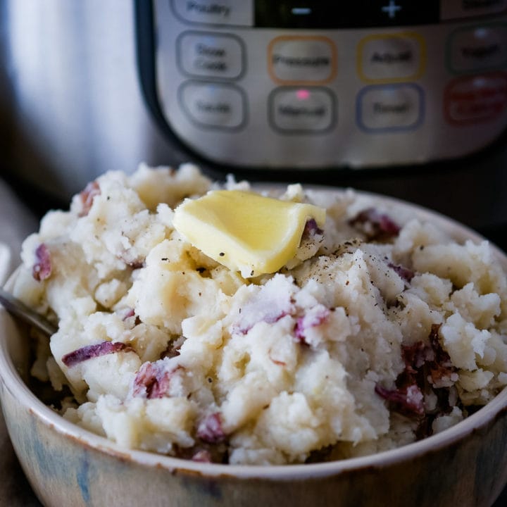 bowl of garlic mashed potatoes in front of the Instant Pot