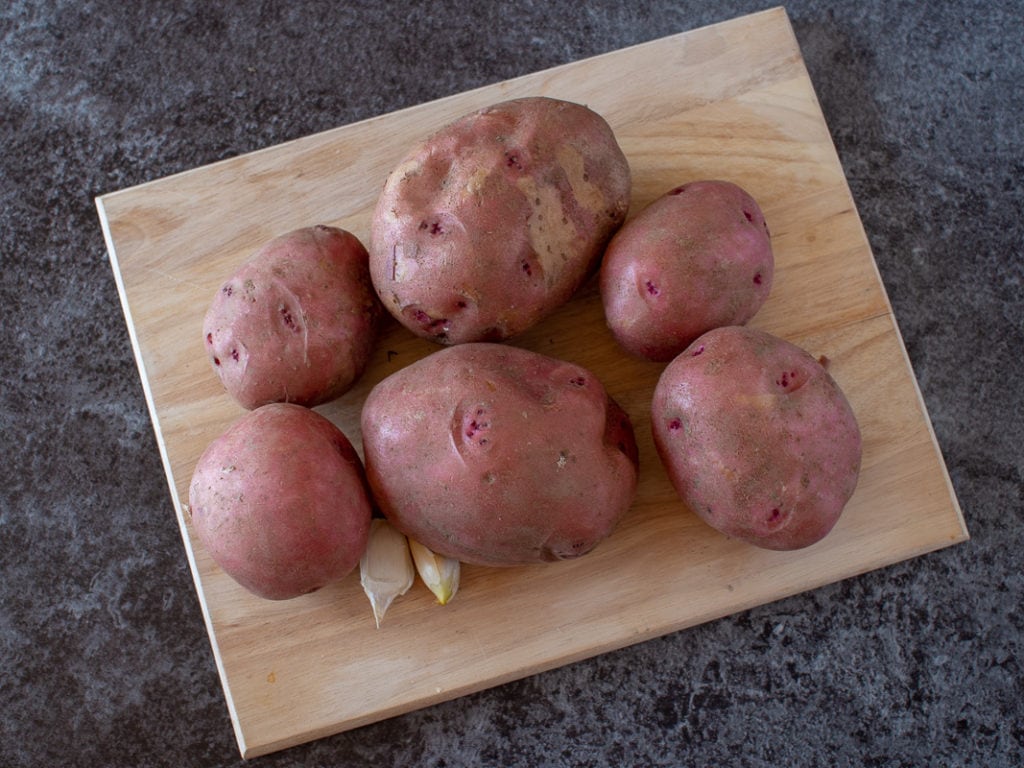 red potatoes on a cutting board