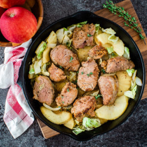 Pork tenderloin medallions in a cast iron skillet from the top