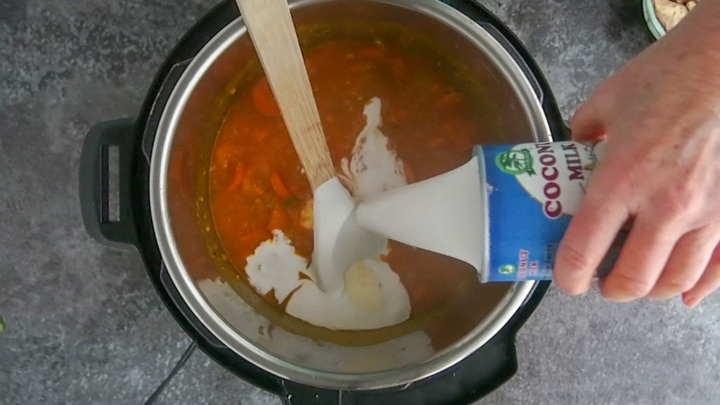adding coconut milk to the Instant Pot chicken stew