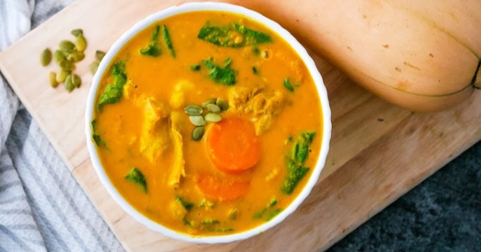 An Instant Pot recipe featuring a spoonful of chicken and squash soup.