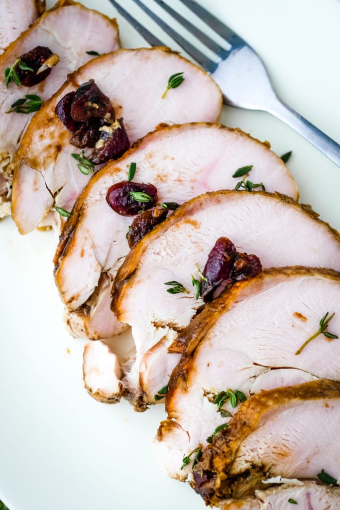 sous vide turkey breast sliced on a plate with a fork - top view