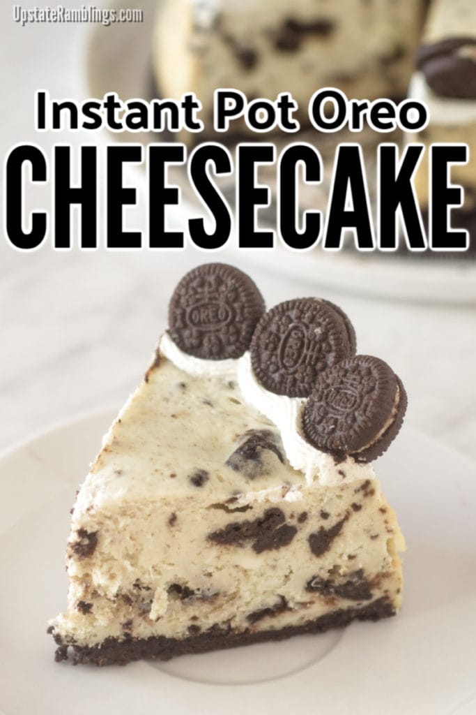 Piece of Instant Pot Oreo cheesecake on a plate in front of rest of cheesecake