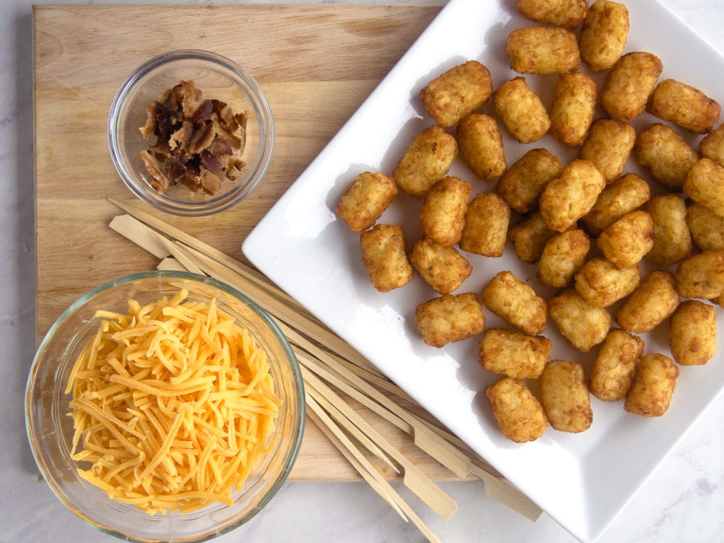 ingredients for loaded tater tot skewers - tater tots, cheese, bacon and skewers